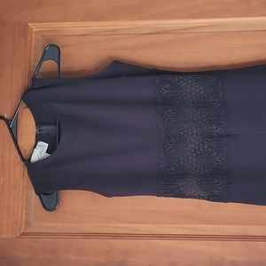 Blue sleeveless jumpsuit with lace see thru mid section.